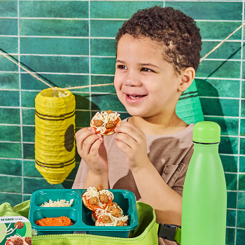 Kid enjoying Nurture Life Lunchkins Meal