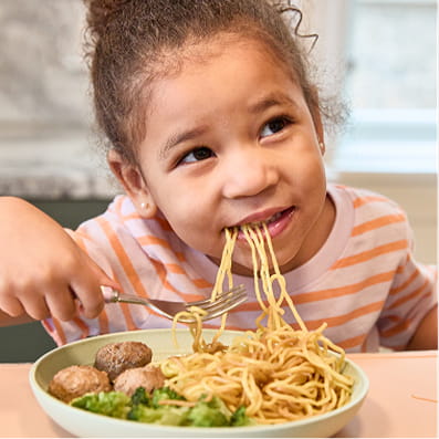 Kid enjoying Nurture Life Meal
