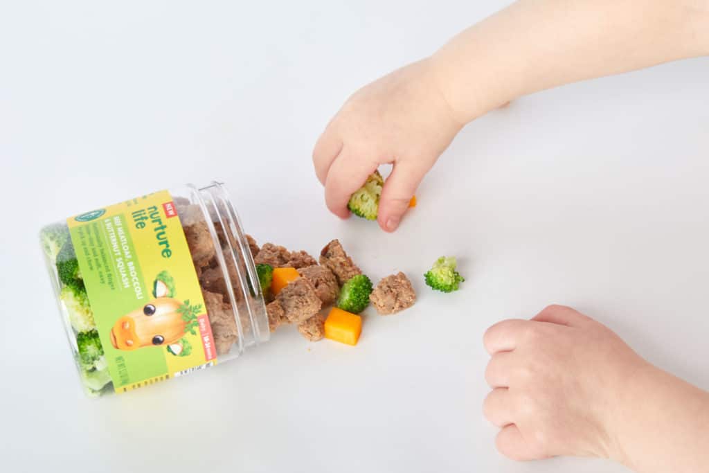 toddler grabbing finger foods
