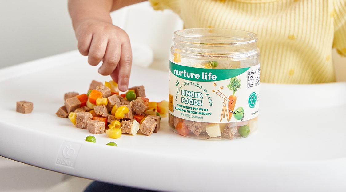 Toddler eating Nurture Life's finger foods