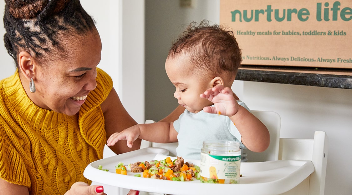 Toddler eating Nurture Life finger foods