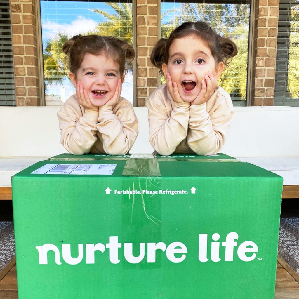 Two kids with Nurture Life delivery box